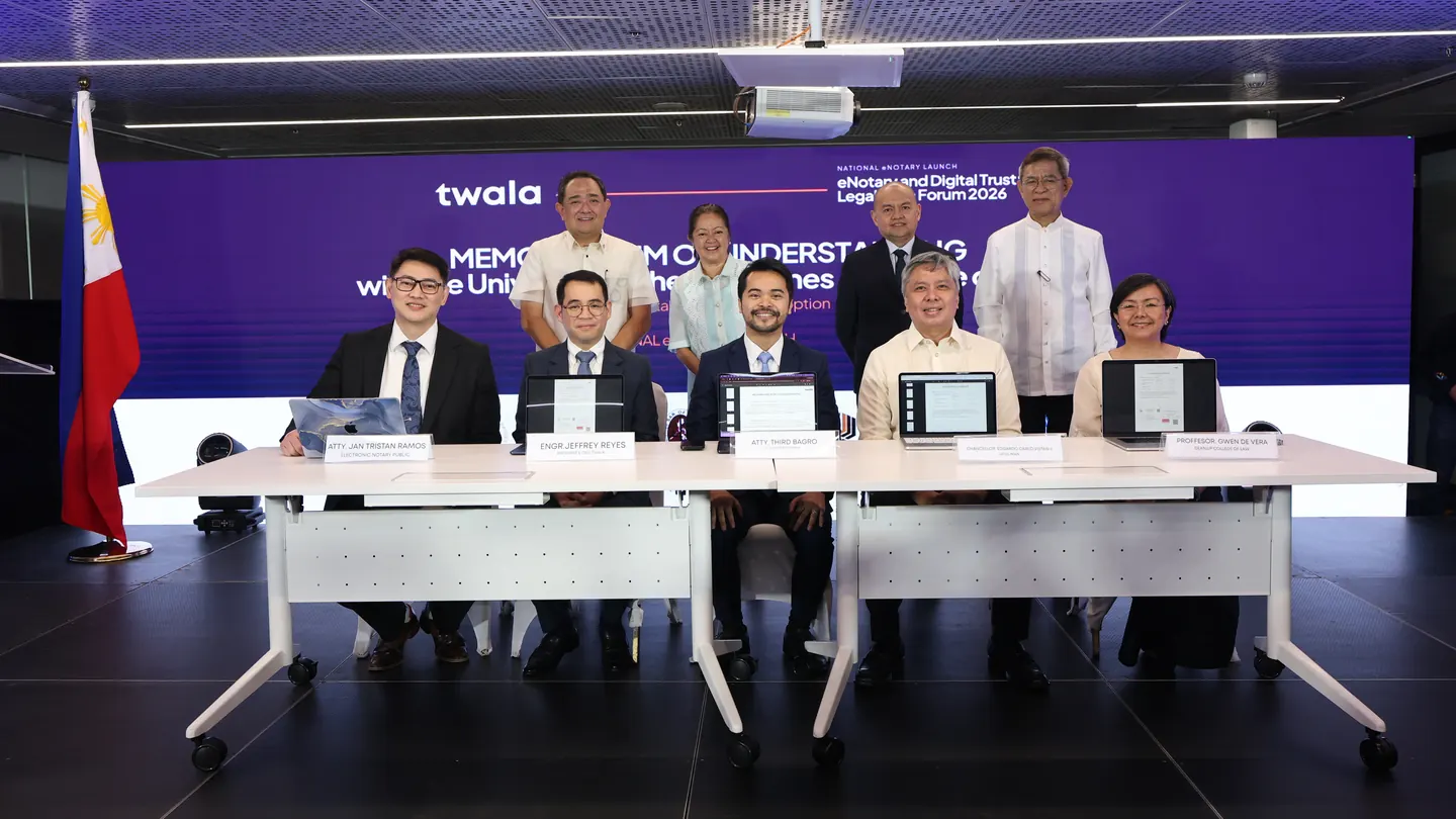 Twala and University of the Philippines College of Law officials at the signing table for their memorandum of understanding, with guests standing behind them